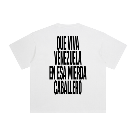 White oversized t-shirt back view with bold black text graphic reading “Que viva Venezuela en esa mierda caballero” – Caracas Merch