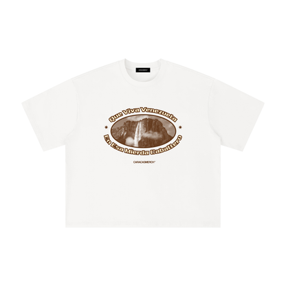 White boxy t-shirt front view with oval graphic featuring Angel Falls image and “Que viva Venezuela en esa mierda caballero” text – Caracas Merch