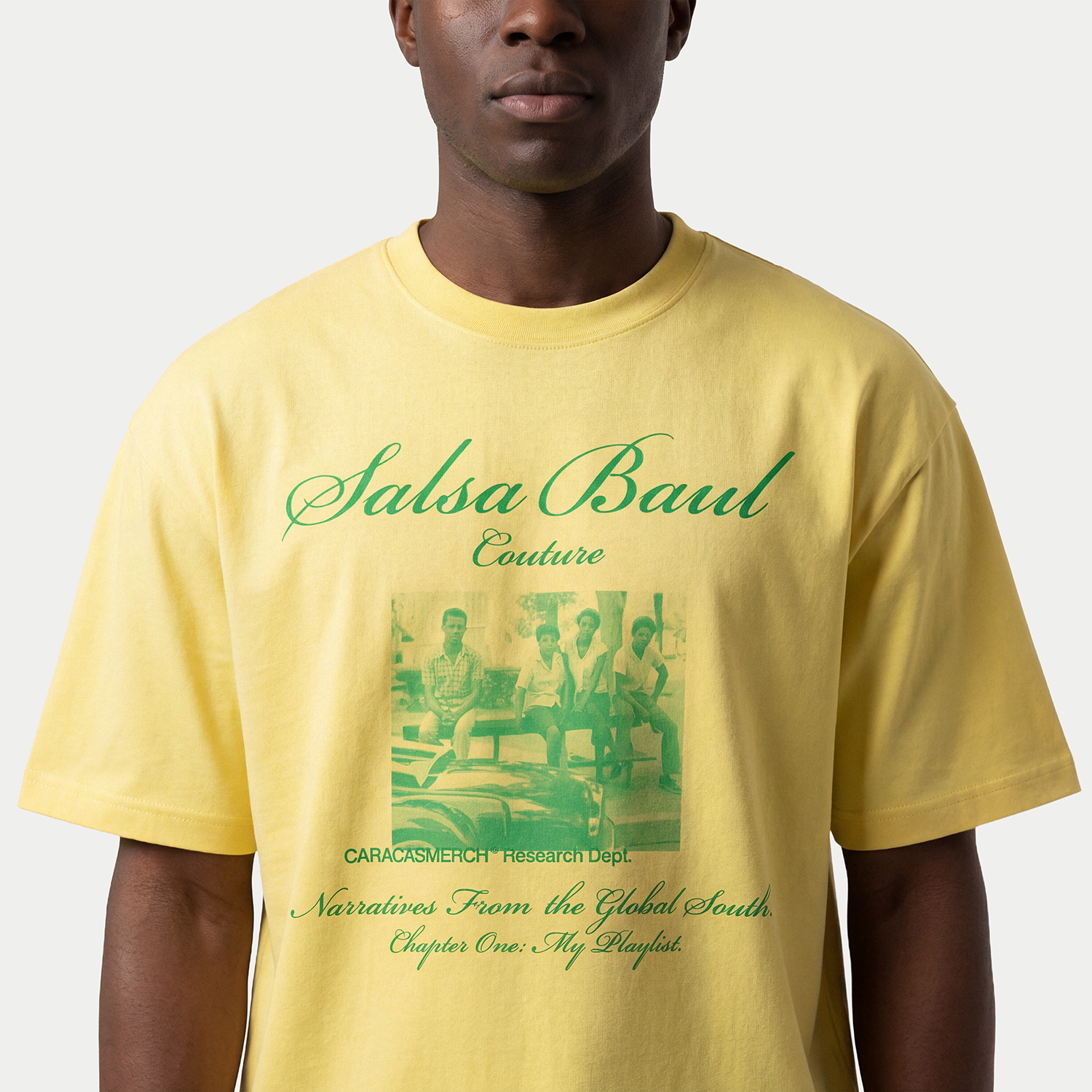 Close up of model wearing yellow with green Salsa Baul Couture graphic t-shirt