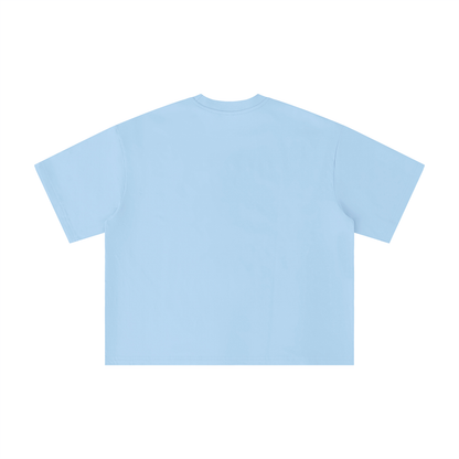Light blue oversized t-shirt back view with bold “Super Fresa” graphic in pink and black with stars and Caracas Merch branding