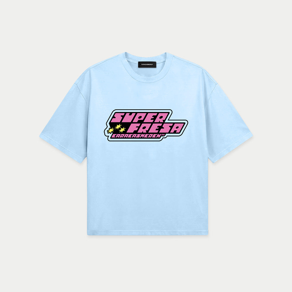 Light blue oversized t-shirt front view with bold “Super Fresa” graphic in pink and black with stars and Caracas Merch branding