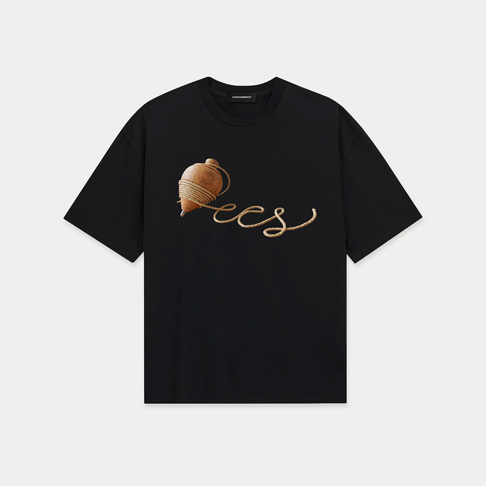 Black oversized t-shirt front view with wooden spinning top graphic forming “ccs” in rope-style lettering – Caracas Merch