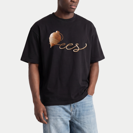 Male model wearing black oversized t-shirt front view with wooden spinning top graphic forming “ccs” in rope-style lettering – Caracas Merch