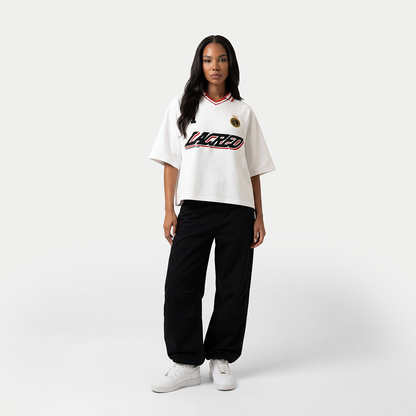 Full body view of model styled in un lacreo white women’s jersey