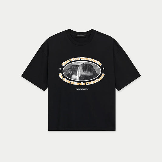 Black boxy t-shirt front view with oval graphic featuring Angel Falls image and “Que viva Venezuela en esa mierda caballero” text – Caracas Merch