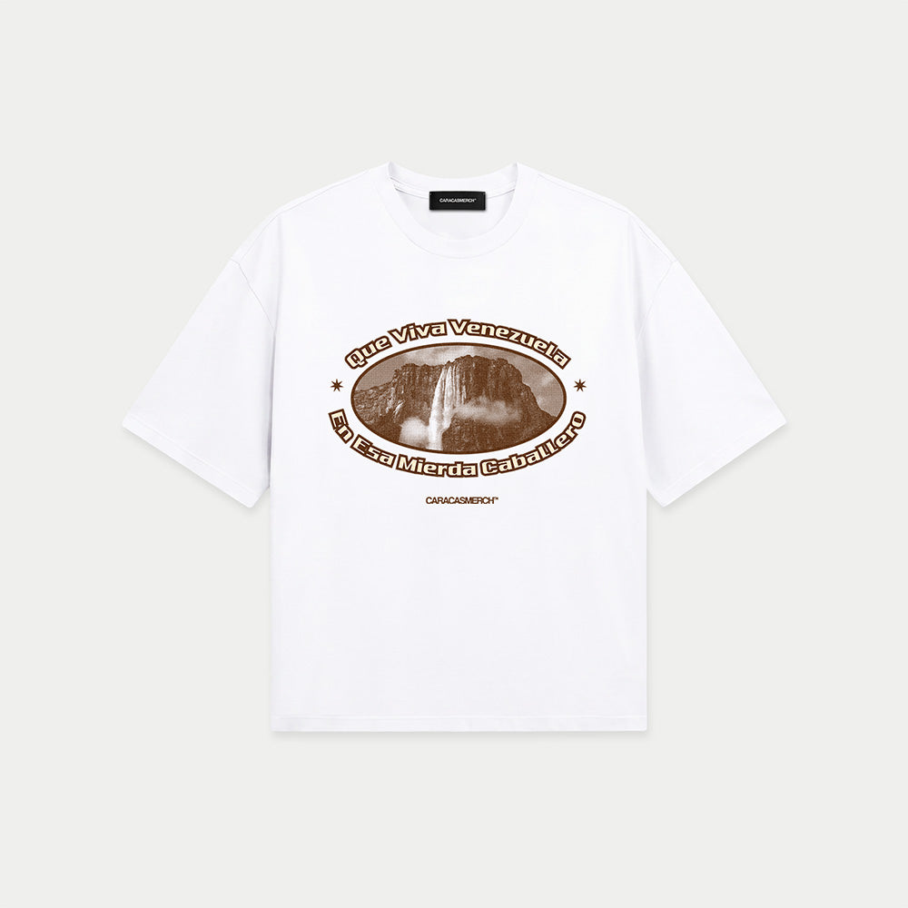 White boxy t-shirt front view with oval graphic featuring Angel Falls image and “Que viva Venezuela en esa mierda caballero” text – Caracas Merch