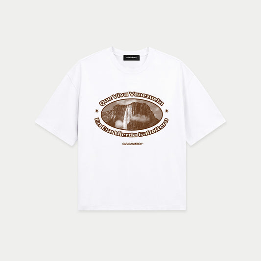 White boxy t-shirt front view with oval graphic featuring Angel Falls image and “Que viva Venezuela en esa mierda caballero” text – Caracas Merch