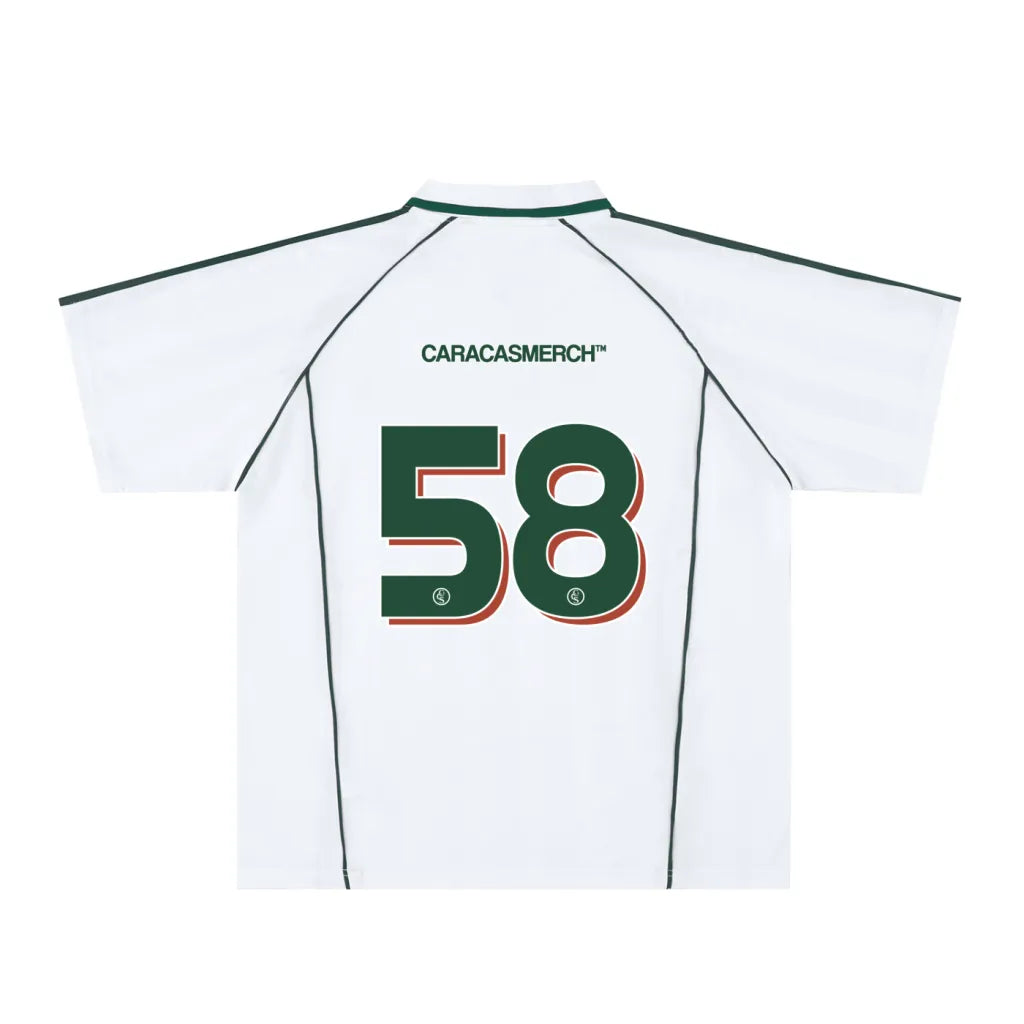 White soccer-style jersey back view with “CARACASMERCH” text on upper back and large number 58 in green with red outline – Caracas Merch