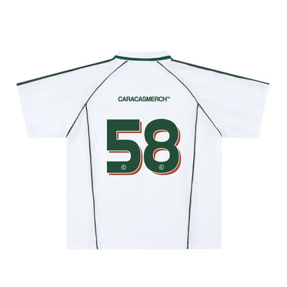 White soccer-style jersey back view with “CARACASMERCH” text on upper back and large number 58 in green with red outline – Caracas Merch